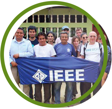 People standing behind a blue IEEE flag.